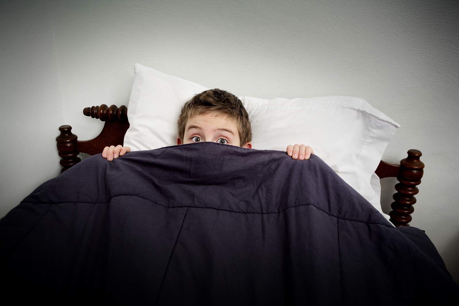 bigstock-boy-hiding-in-bed-under-the-co-40815694-1526939695865.jpg