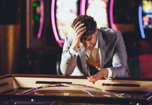 despondent-gambler-losing-at-the-casino-300x207.jpg